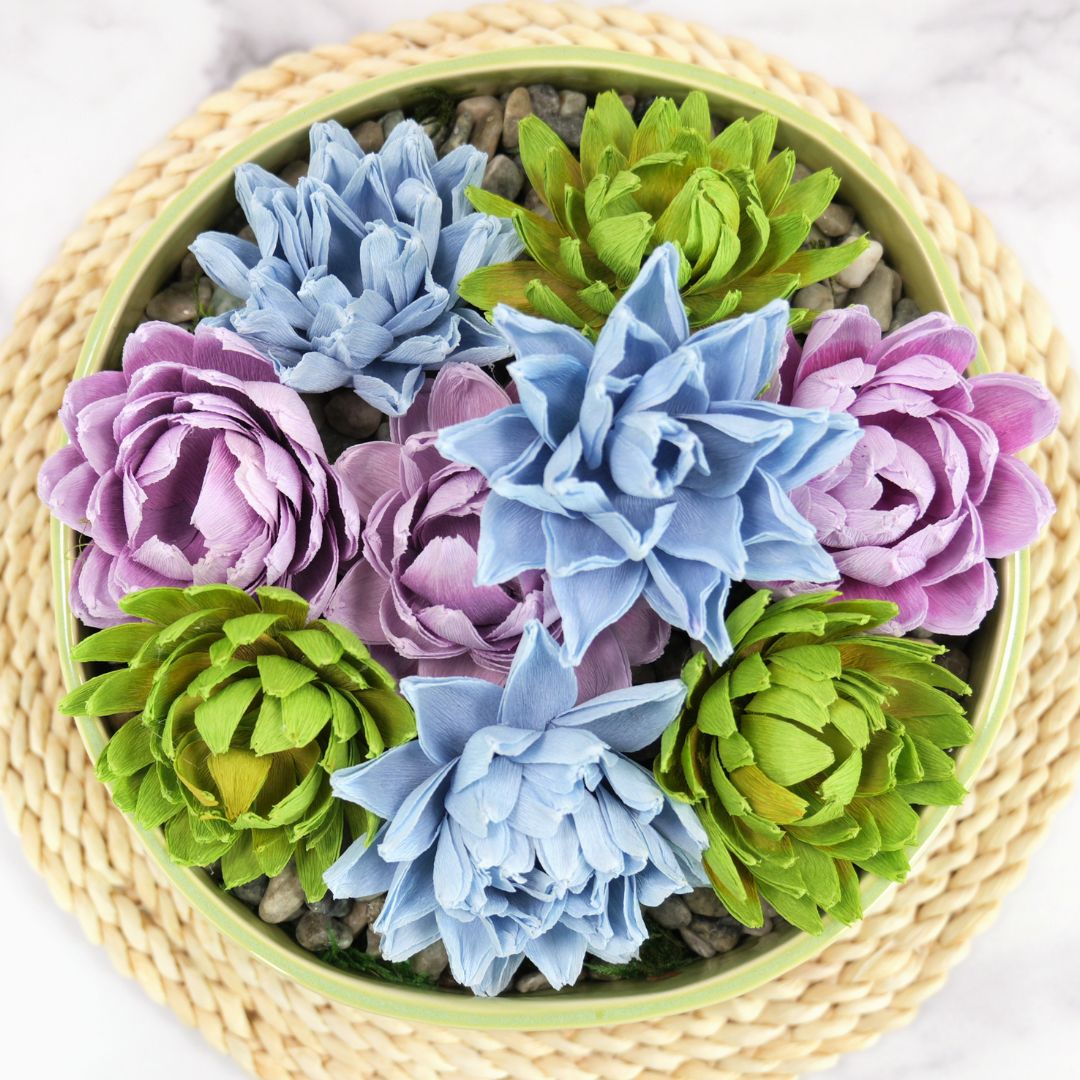 Crepe paper succulents in a large potted bowl in purple, green and blue.
